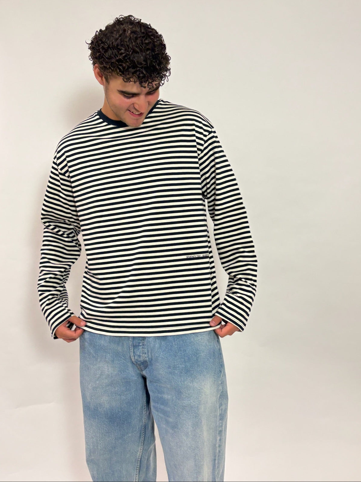 Gestreepte longsleeve navy – Seventy Two Seventy One van 72.71 Clothing – voorkant, gedragen door een mannelijk model met een lichte jeans